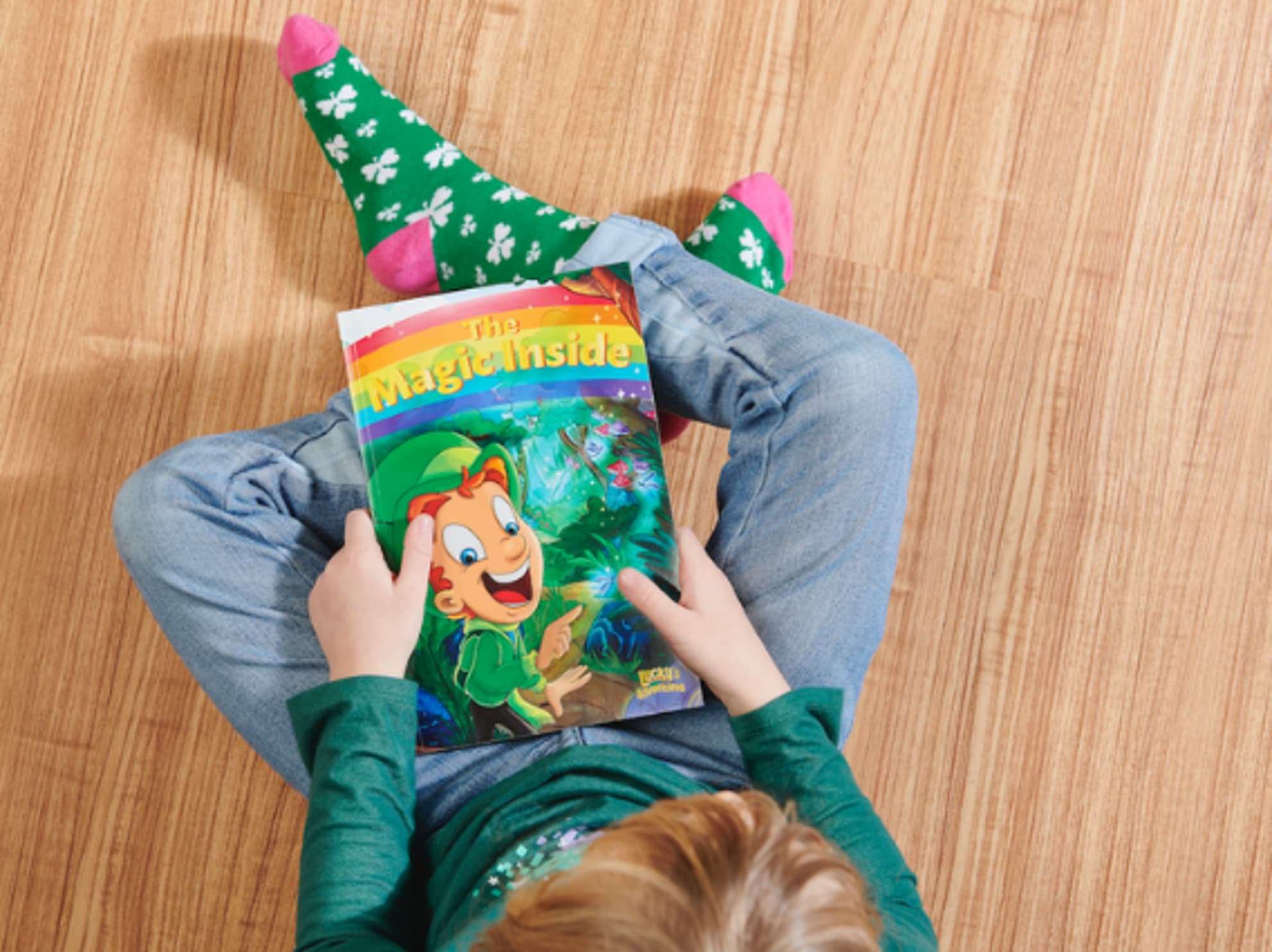 Child holding "The Magic Inside" book on their lap